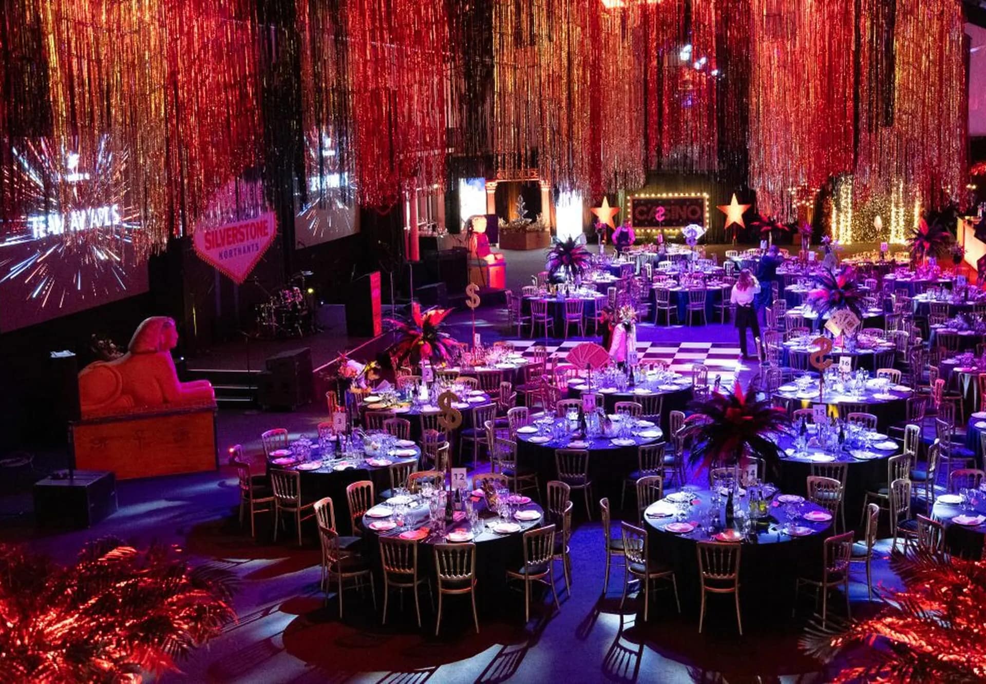 Vibrant corporate gala setup with tables, lighting, and décor